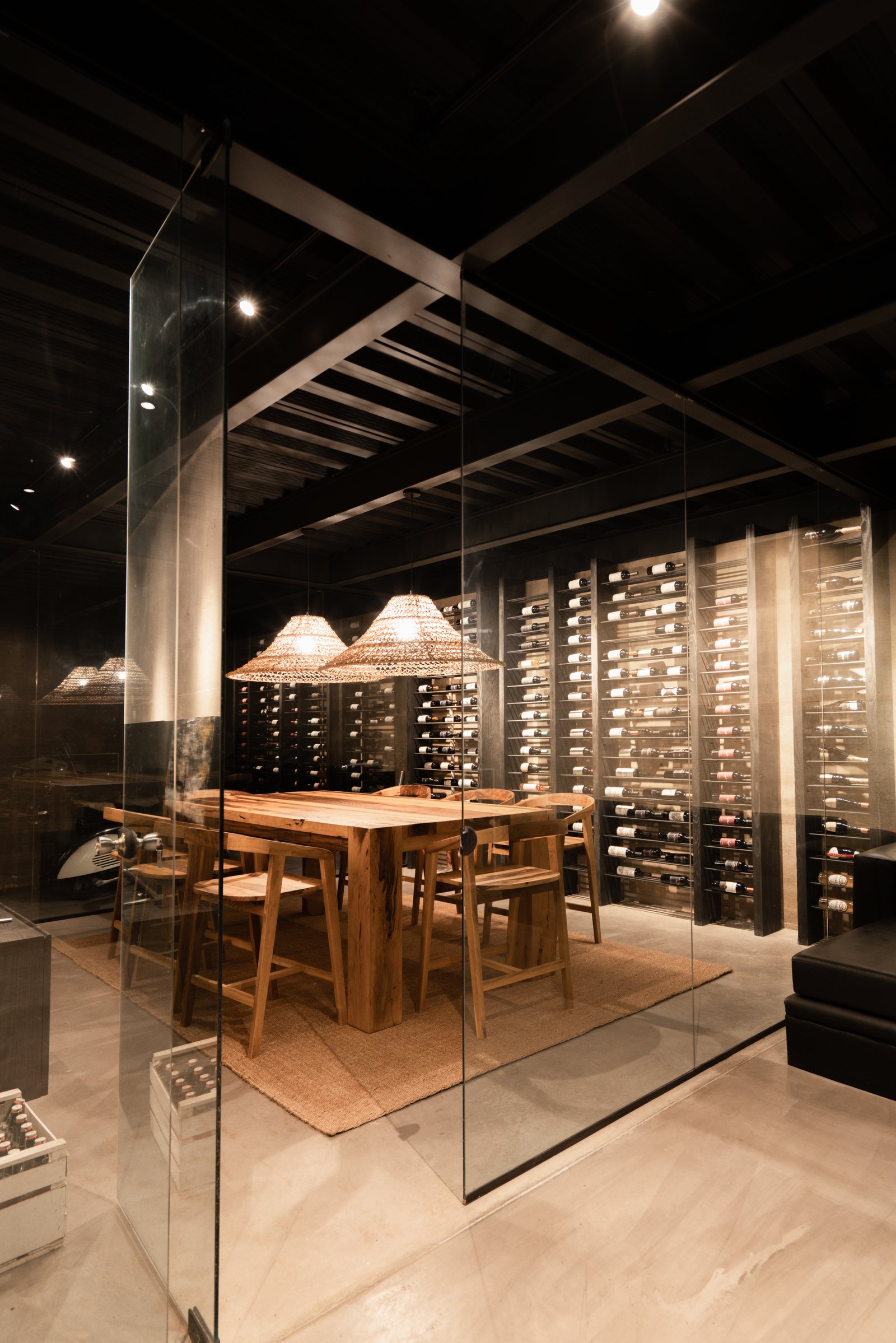 Glass-enclosed wine room in a custom home by Reschka Design Build
